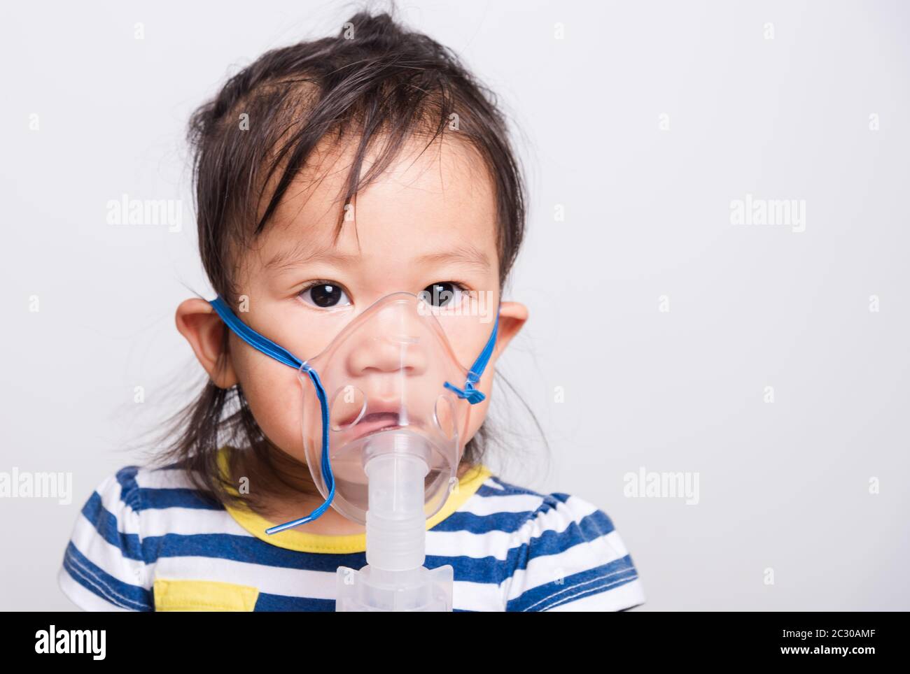 Closeup Asian face, Little baby girl sick her using steam inhaler