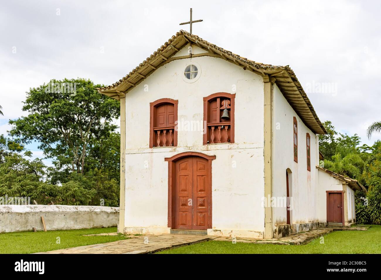 Small withe old church and crucifix in colonial architecture Stock Photo