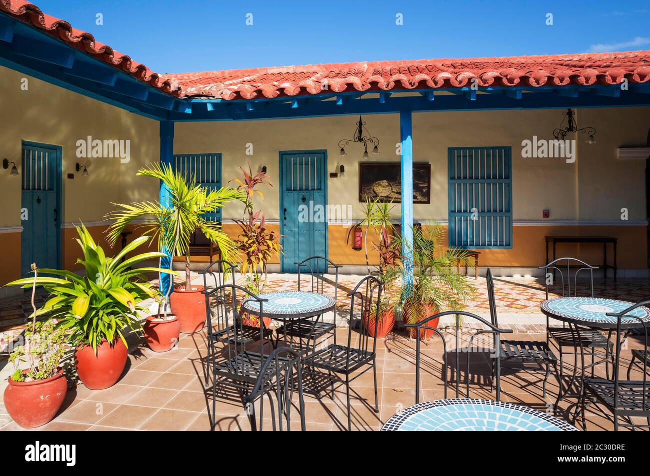 Inner courtyard of the Hotel Plaza Colon., Gibara, Cuba Stock Photo