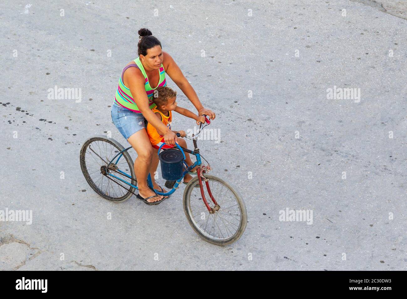 Woman with child on a bicycle, Niquero, Cuba Stock Photo