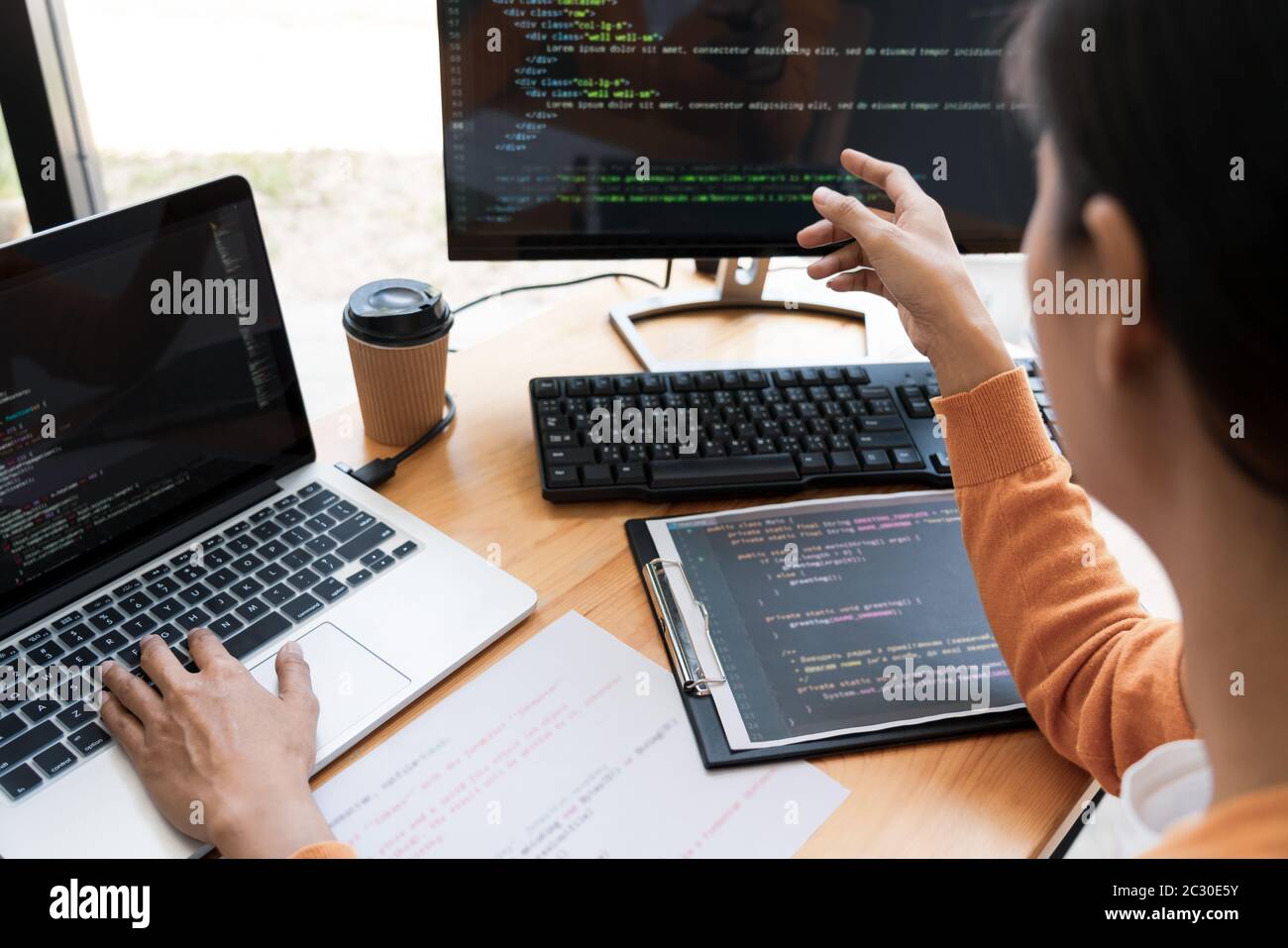 Asian team Outsource Developer Looking Screen Programming Code Working with Laptop Computer Software Stock Photo