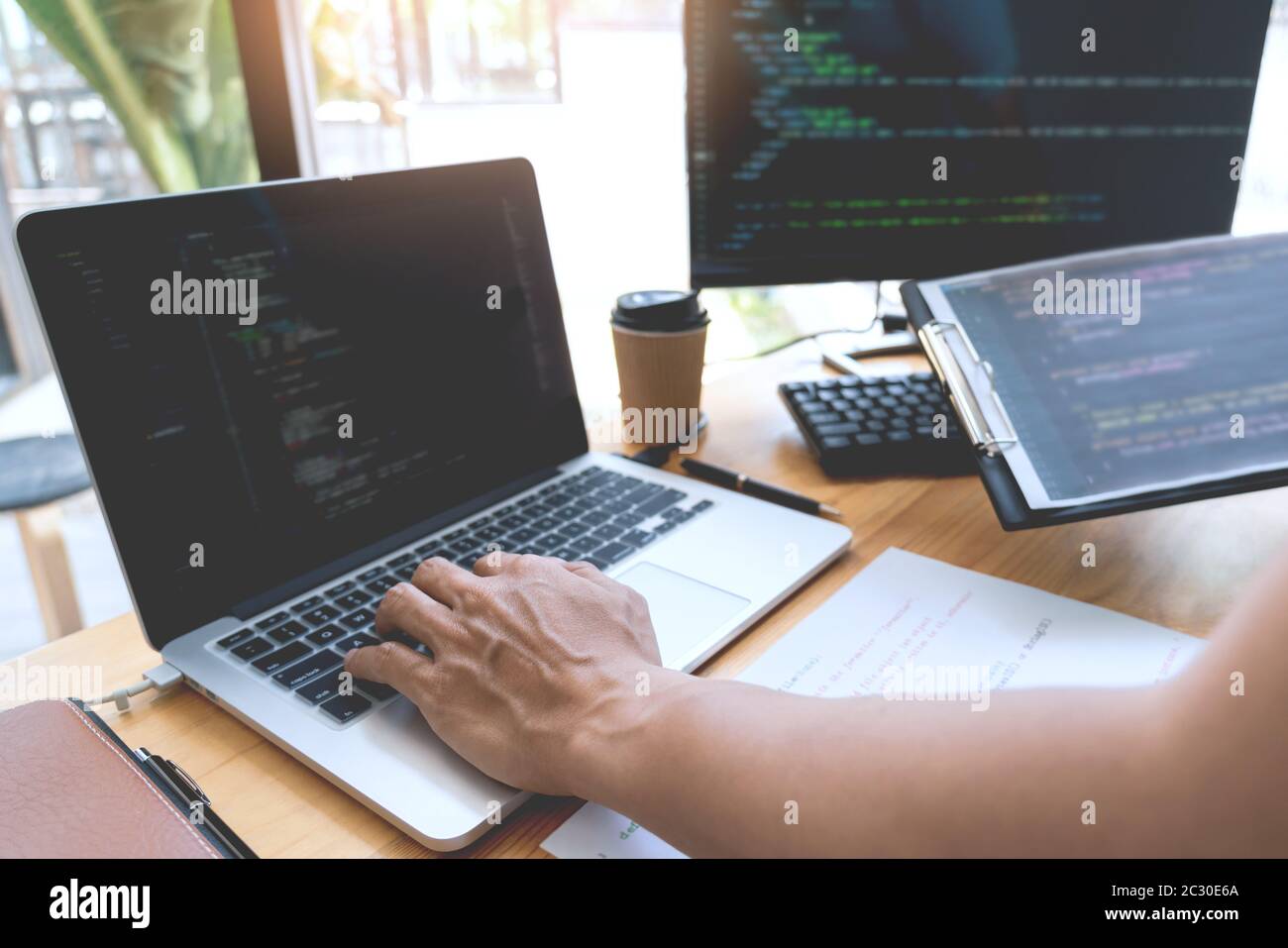 Asian team Outsource Developer Looking Screen Programming Code Working with Laptop Computer Software Stock Photo