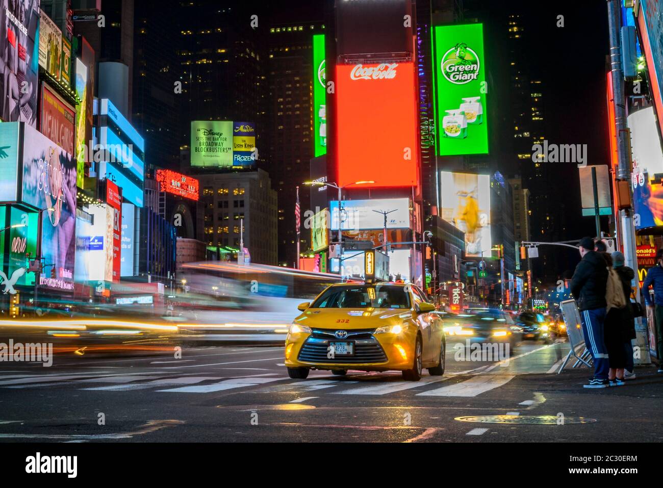 Typical yellow taxi in traffic, Times Square at night, Midtown Manhattan, New York City, New York State, USA Stock Photo