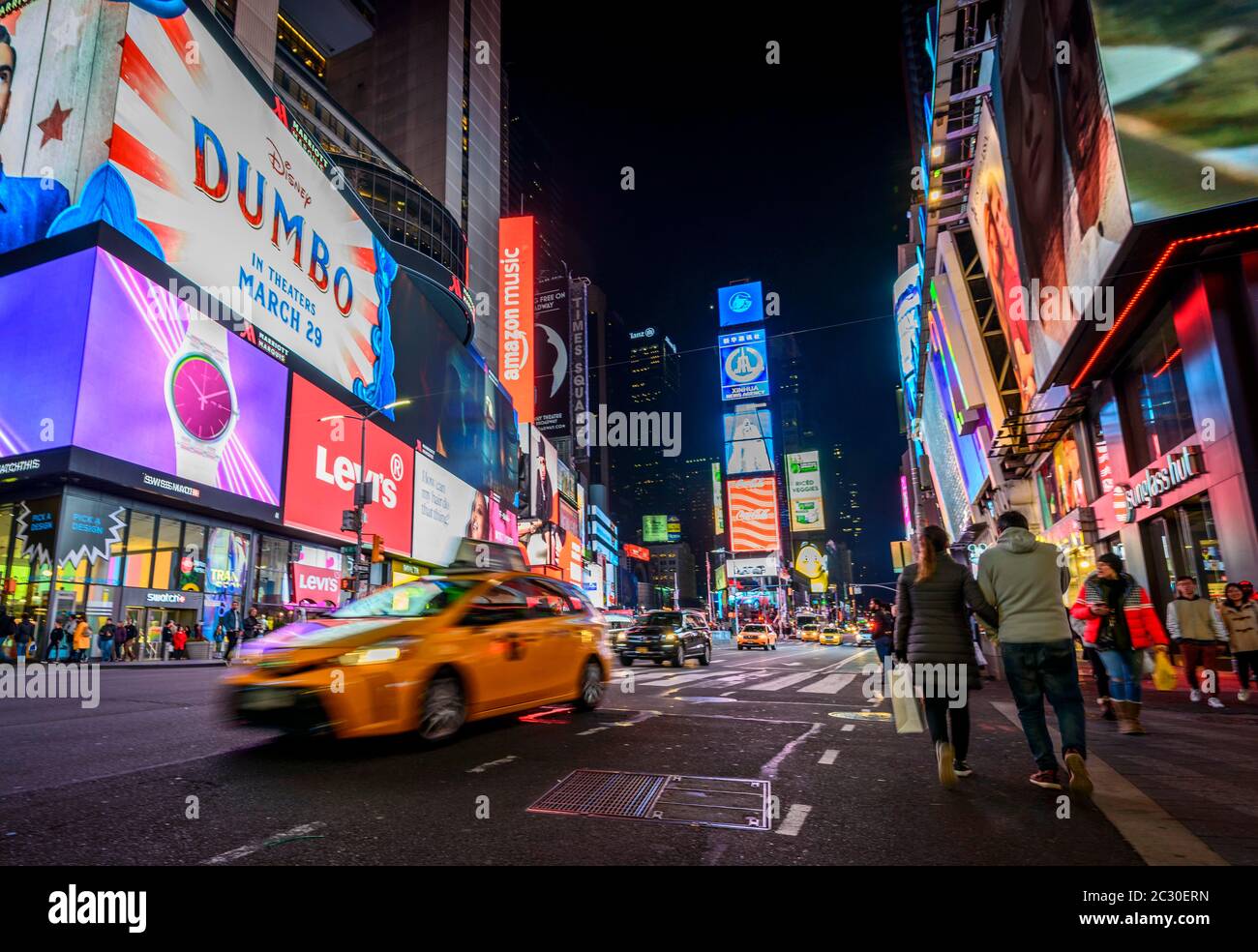Typical yellow taxi at Times Square at night, Midtown Manhattan, New York City, New York State, USA Stock Photo
