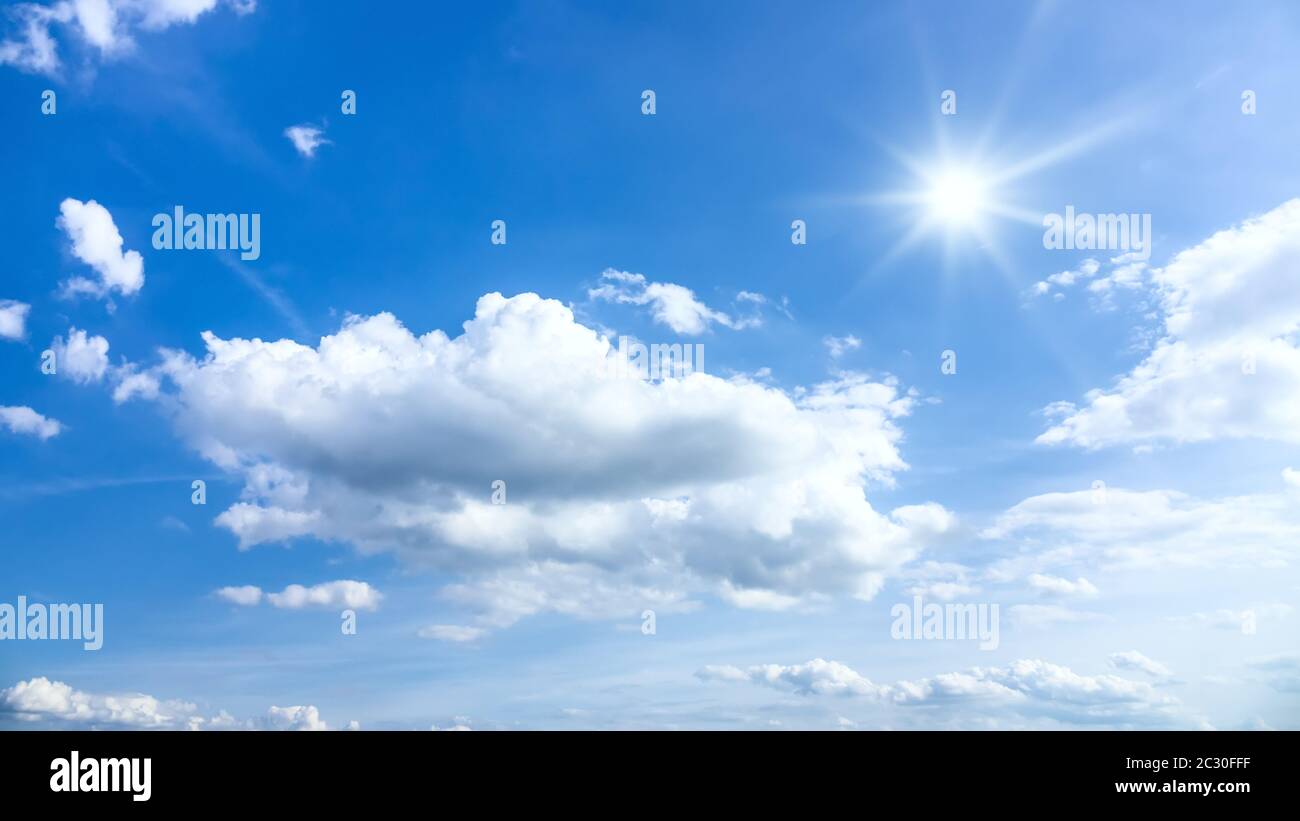 typical beautiful blue sky sun clouds background Stock Photo