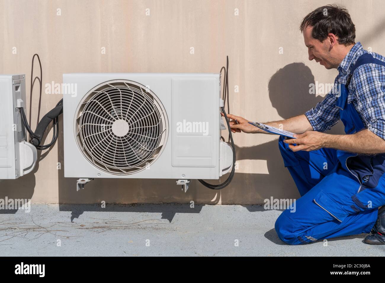Man Doing Heating, Ventilation, And Air Conditioning Inspection Stock Photo