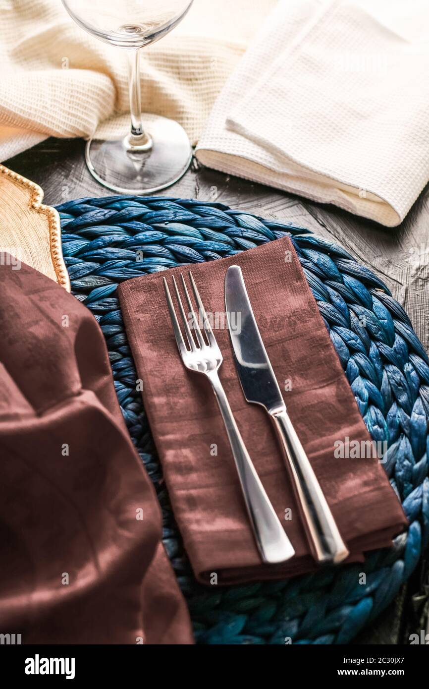 Holiday table setting with brown napkin and silver cutlery, food styling props, vintage set for wedding, event, date, party or l Stock Photo