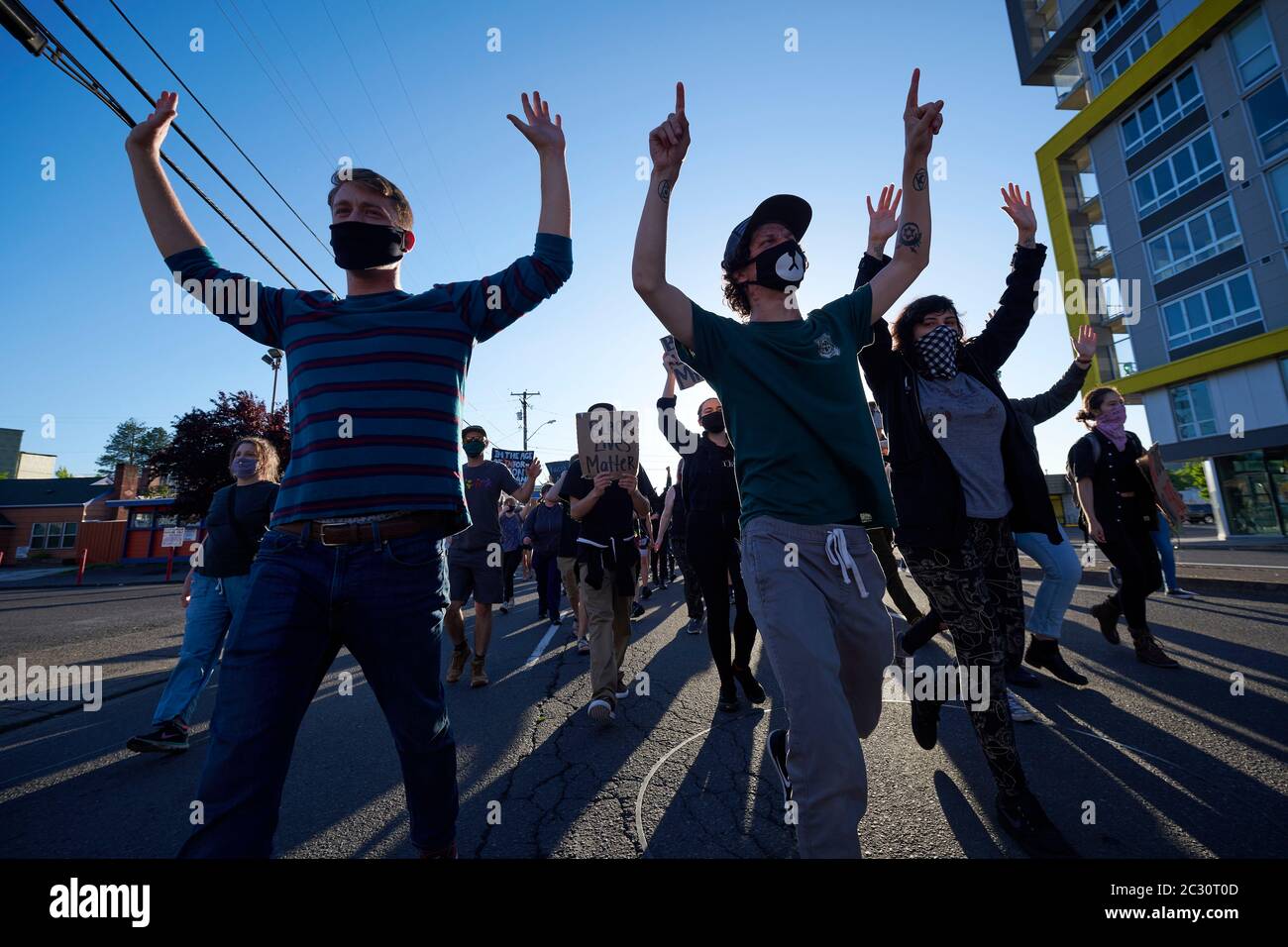Chanting 'Hands up, don't shoot,' protesters march with their hands raised during a June 3, 2020, Black Lives Matter protest in Eugene, Oregon. Stock Photo