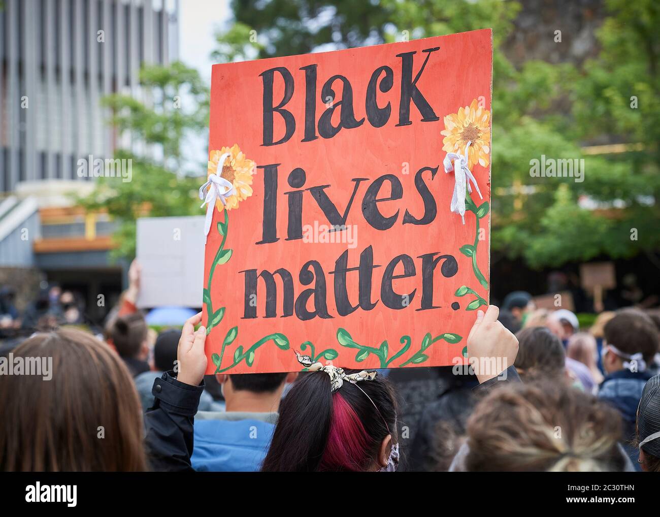 Many carrying signs, people participate in a June 7, 2020, Black Lives Matter protest in Eugene, Oregon. Stock Photo