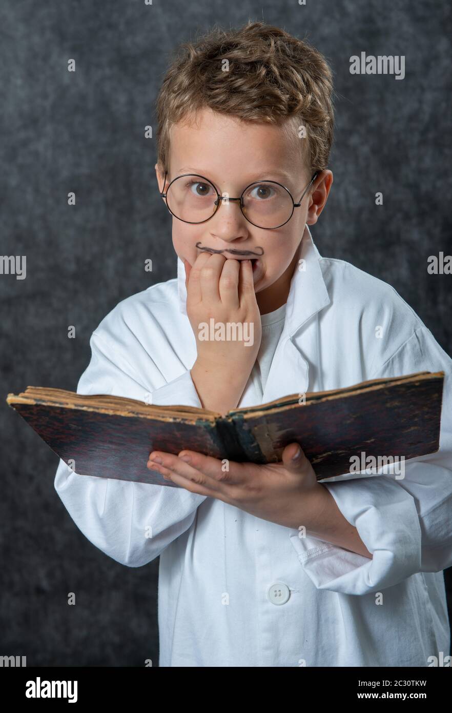 cheerful boy retro with a white blouse reading a book Stock Photo