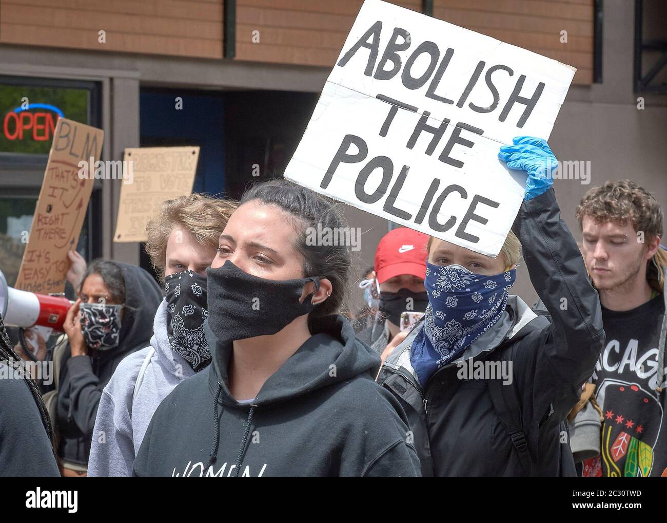 Many carrying signs, people march along a street during a June 7, 2020, Black Lives Matter protest in Eugene, Oregon. Stock Photo