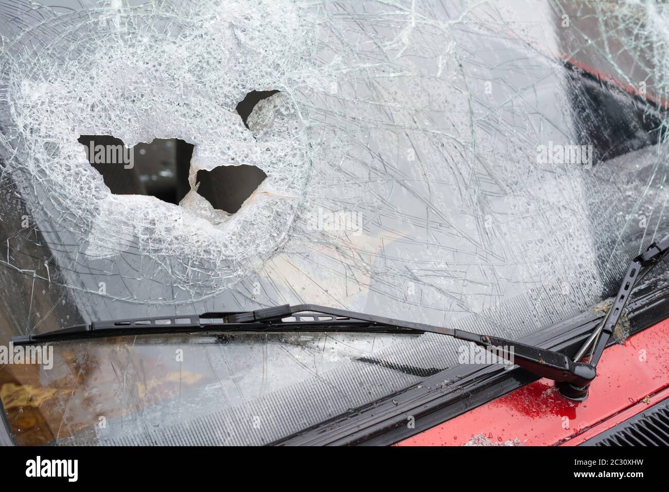 Close up of a broken car windshield smashed by a thief. Damaged glass from car theft Stock Photo