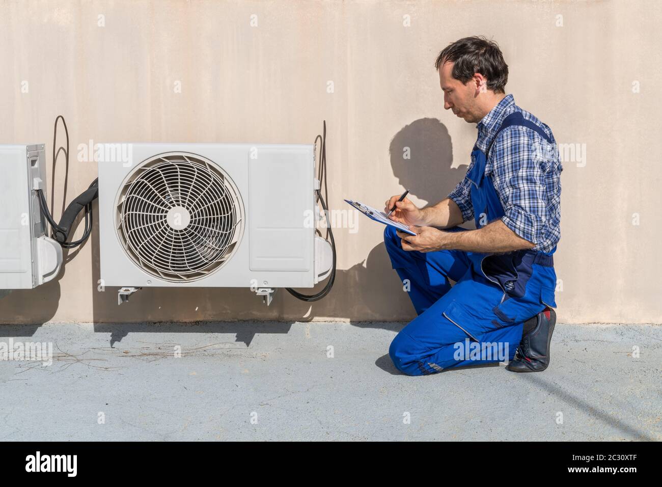 Man Doing Heating, Ventilation, And Air Conditioning Inspection Stock Photo