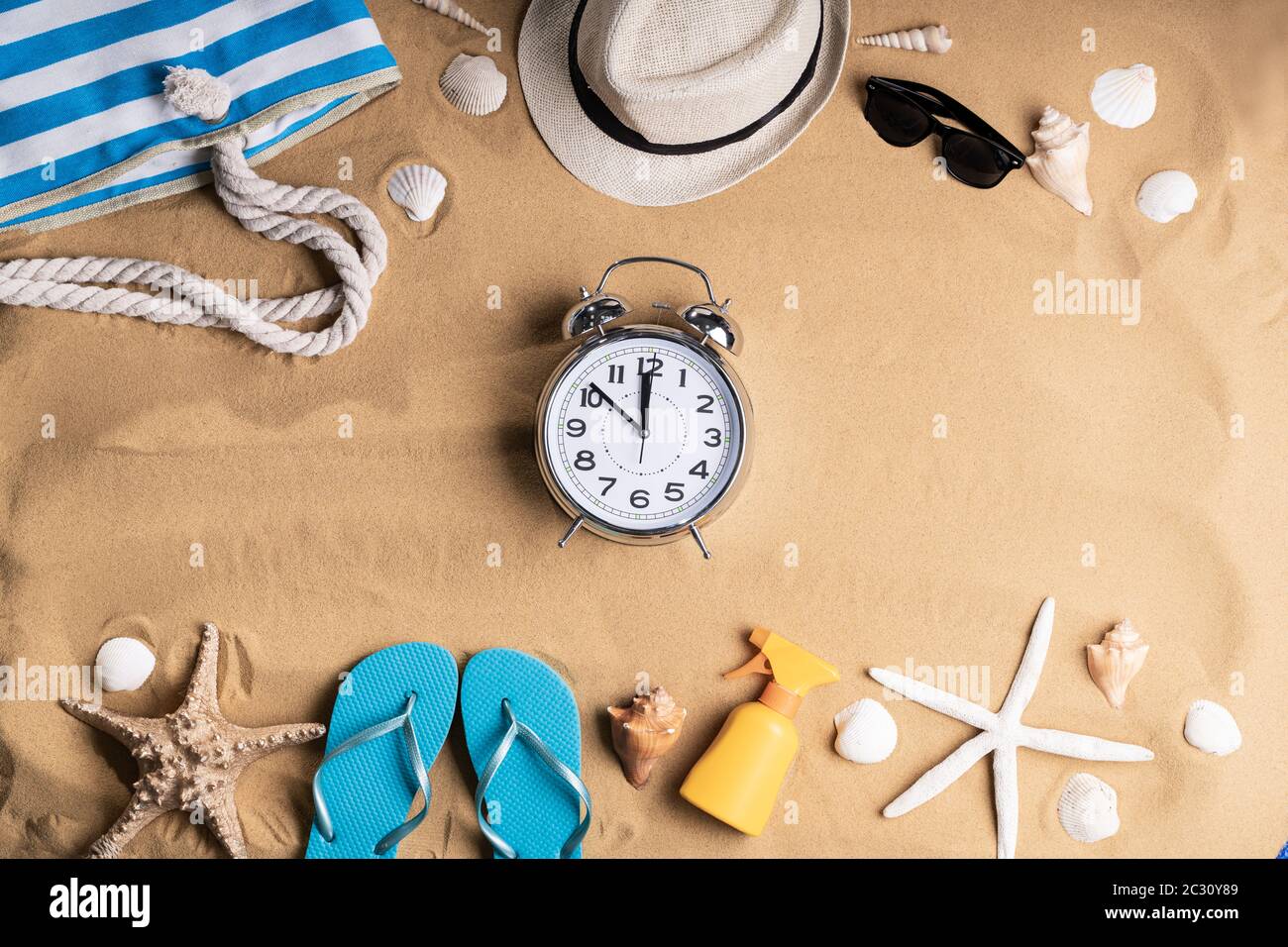 Alarm Clock In Sand On Sunny Tropical Beach Stock Photo