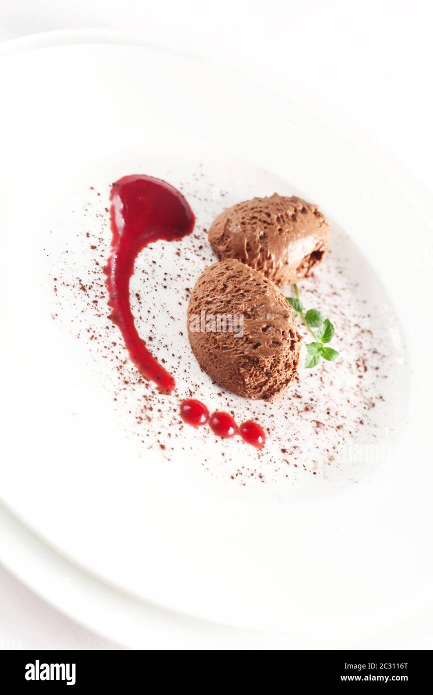 Mousse Au Chocolat With Red Sauce On A White Plate Stock Photo