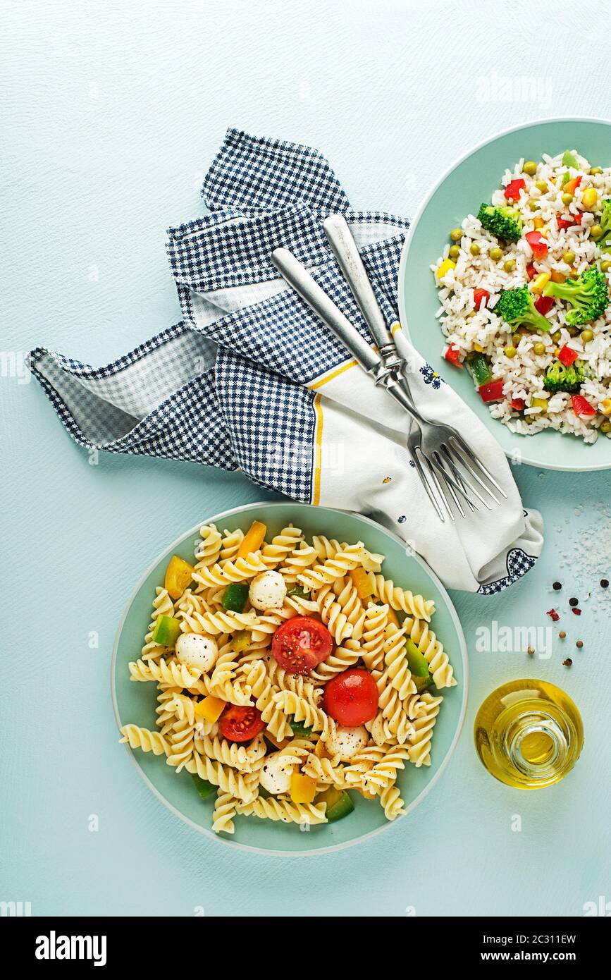 Fresh pasta salad and rice salad with mixed vegetables in a bowl on