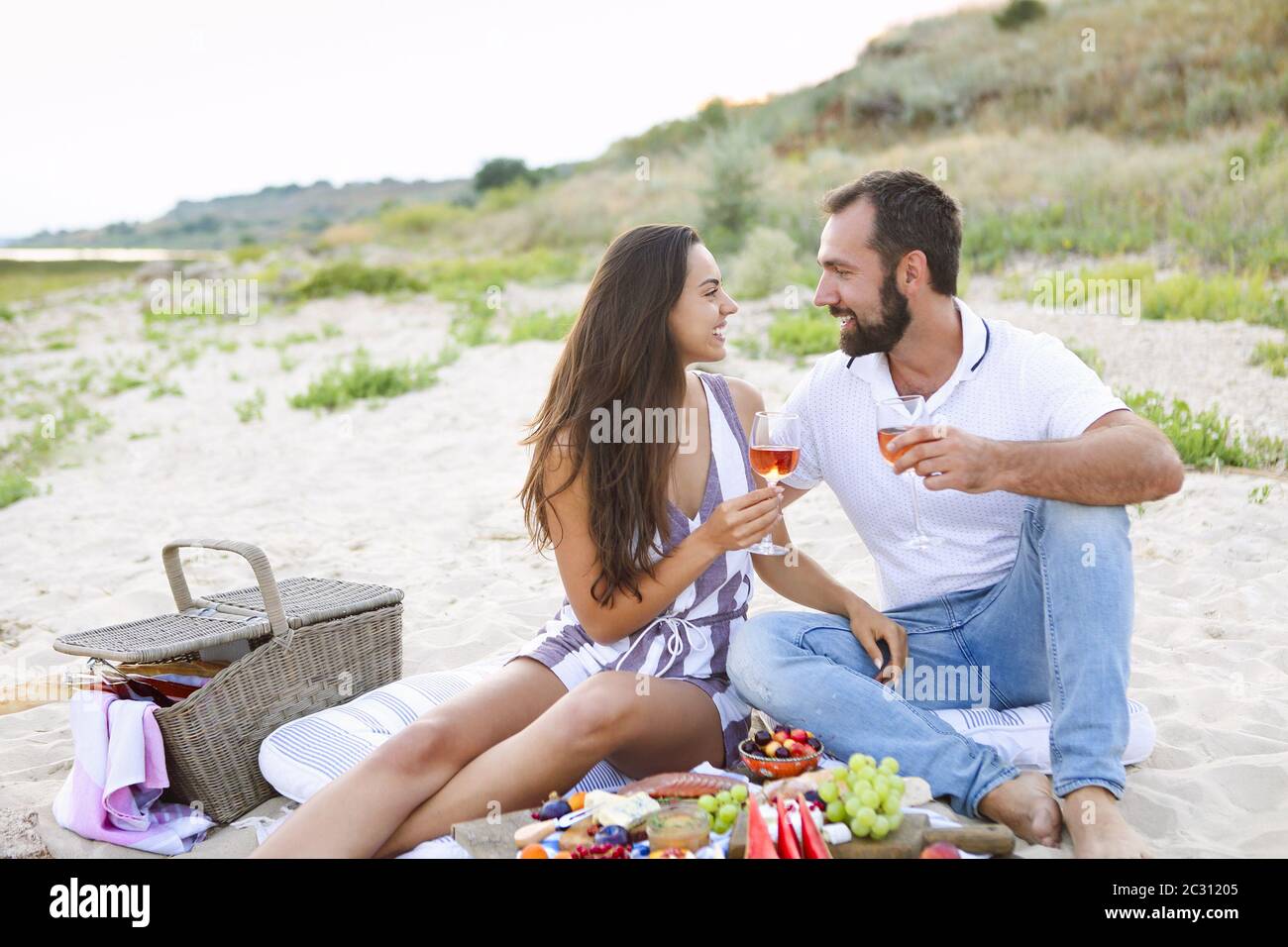 Couple drinking rose wine at picnic on the beach Stock Photo - Alamy
