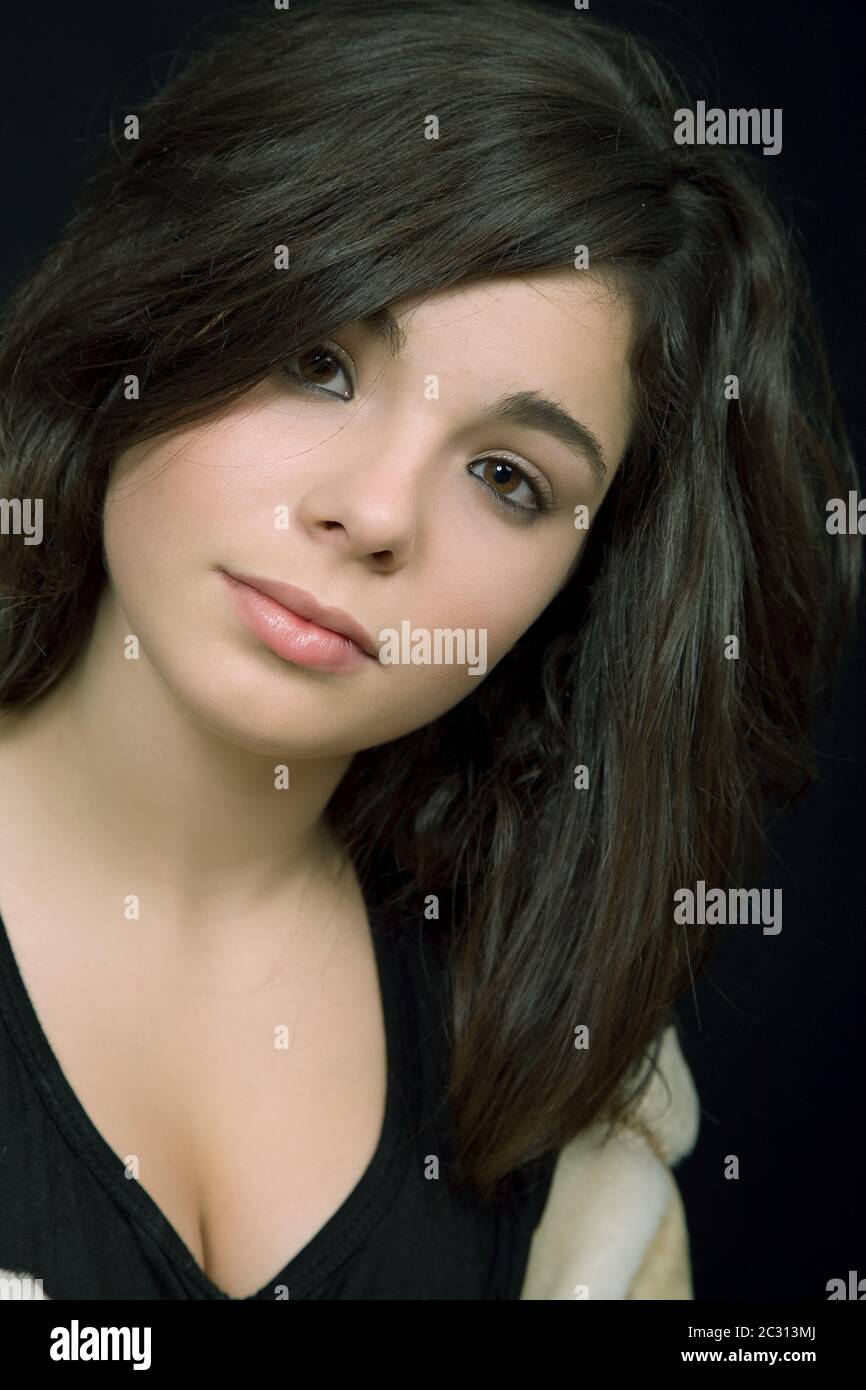 young beautiful brunette portrait against black background Stock Photo ...