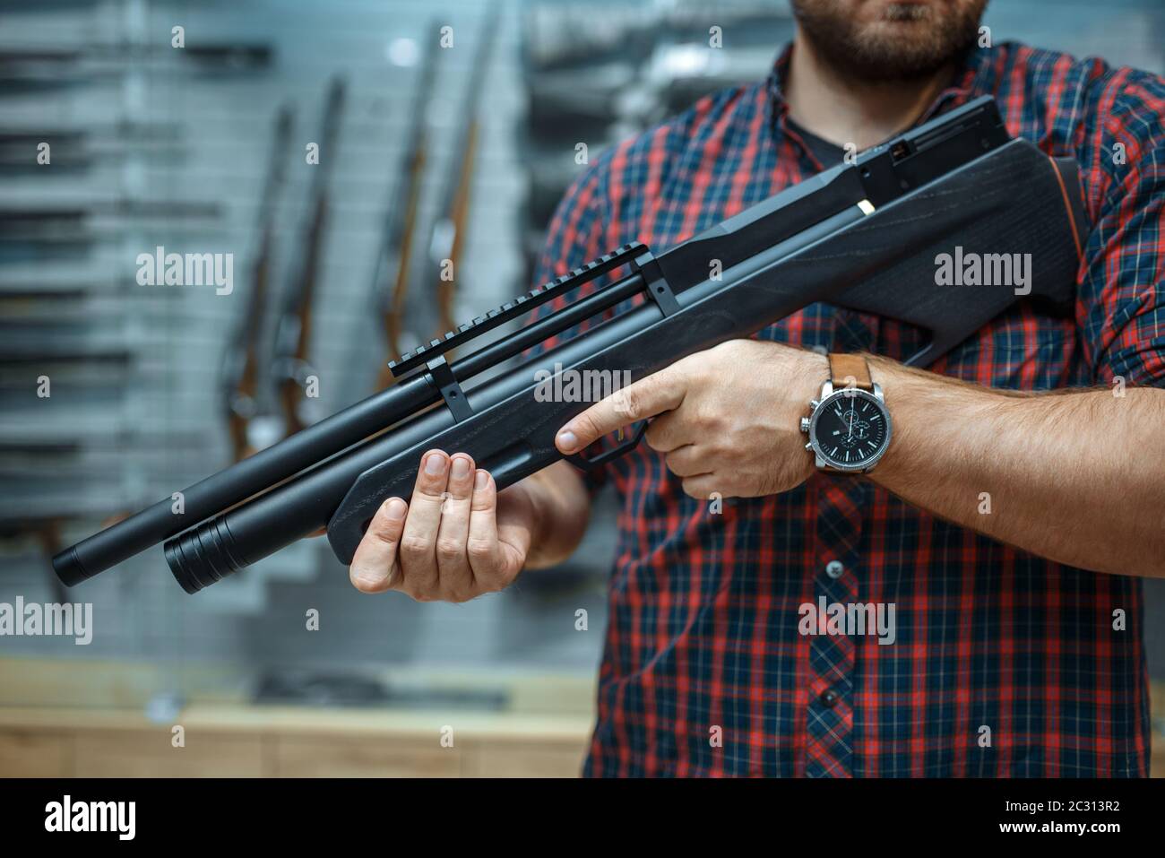 Male person with pneumatic rifle at showcase in gun shop. Euqipment for  hunters on stand in weapon store, hunting and sport shooting hobby Stock  Photo - Alamy