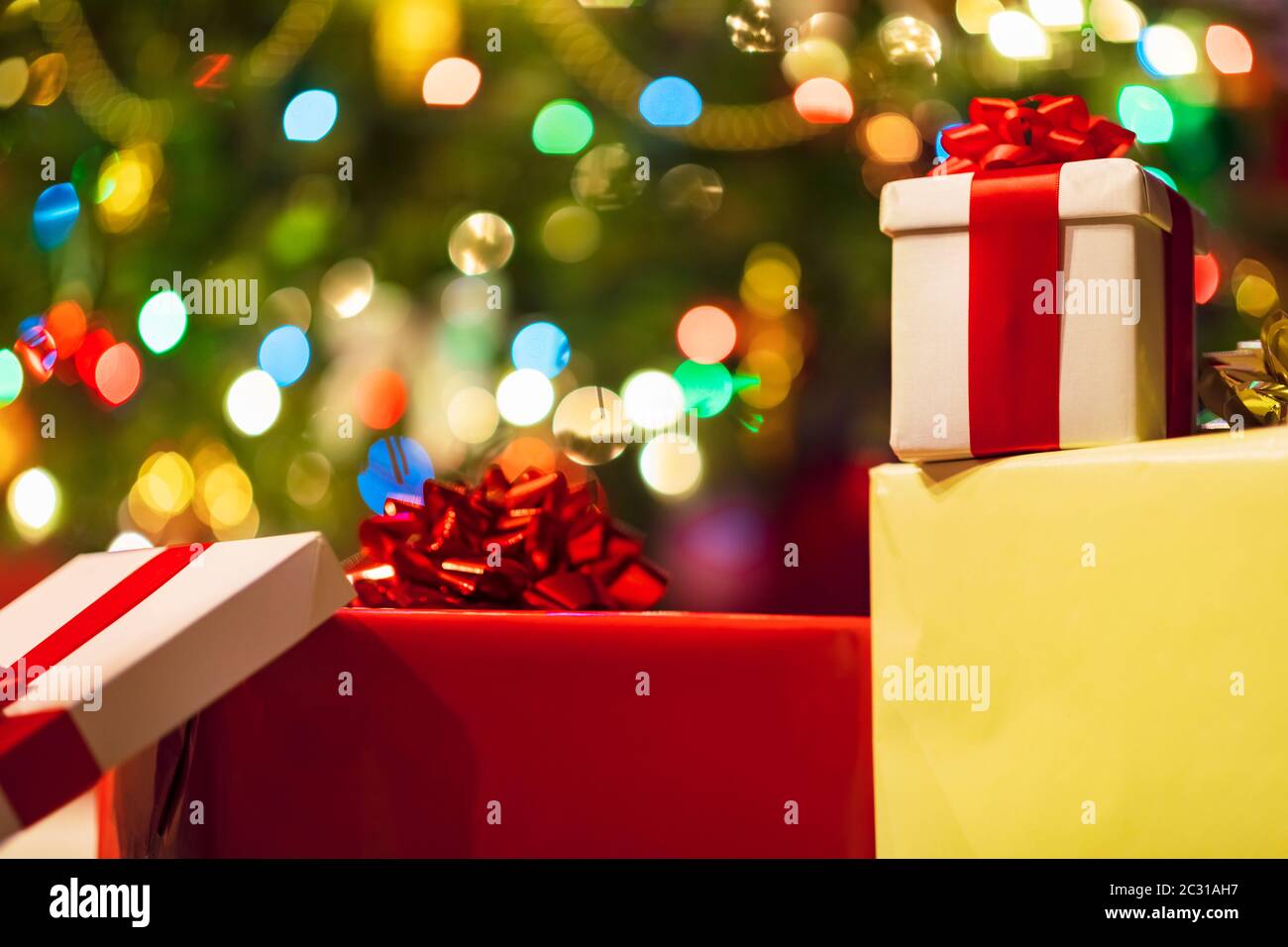 gift boxes with ribbon and bow on holiday lights background Stock Photo ...