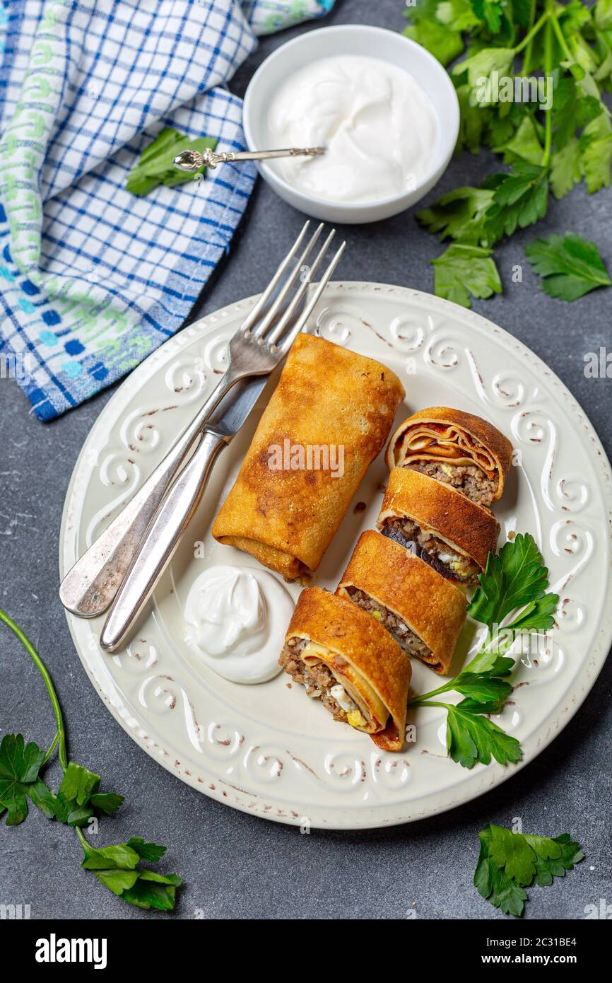 Crepes with meat and egg. Traditional Russian cuisine. Stock Photo