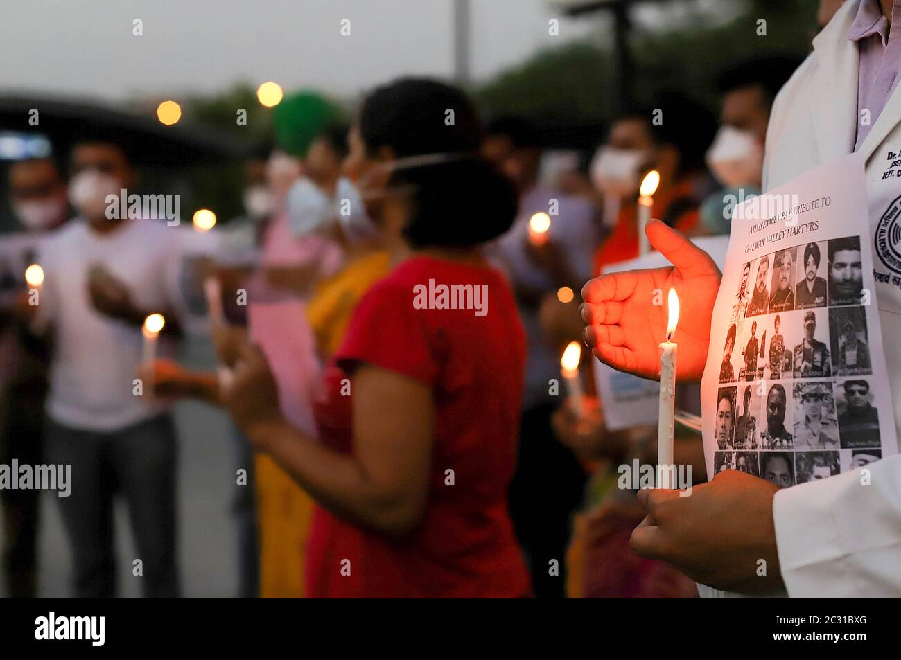 Doctors of All India Institute of Medical Science (AIIMS) hold flamed candles as they pay a tribute to the soldiers who lost their lives following recent clashes between India and China during an anti-China demonstration outside AIIMS hospital in New Delhi. According to Indian media reports, twenty Indian Army personnel, including a colonel were killed during the clashes with Chinese troops in the eastern Ladakh region. Stock Photo