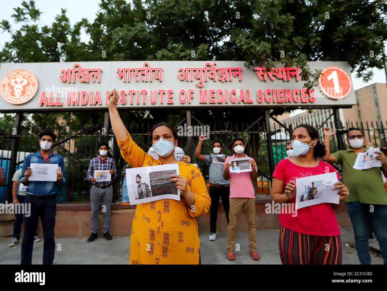 Doctors of All India Institute of Medical Science (AIIMS) gesture hold placards as they pay a tribute to the soldiers who lost their lives following recent clashes between India and China during an anti-China demonstration outside AIIMS hospital in New Delhi. According to Indian media reports, twenty Indian Army personnel, including a colonel were killed during the clashes with Chinese troops in the eastern Ladakh region. Stock Photo