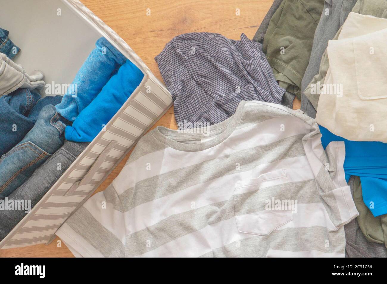 Vertical storage of clothing, Marie Kondo tidying up method, room cleaning concept. Top view Stock Photo