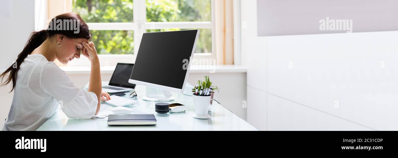 Bad Posture While Using Computer. Stressed Employee Stock Photo