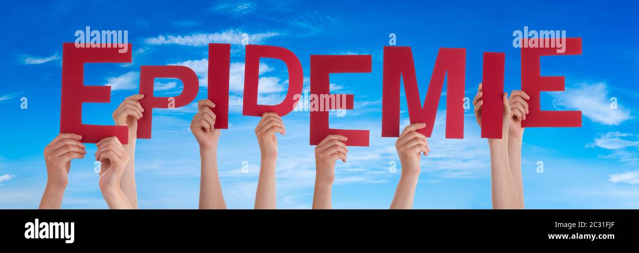 People Hands Holding Red German Word Epidemie Means Epidemic. Blue Sky As Background Stock Photo