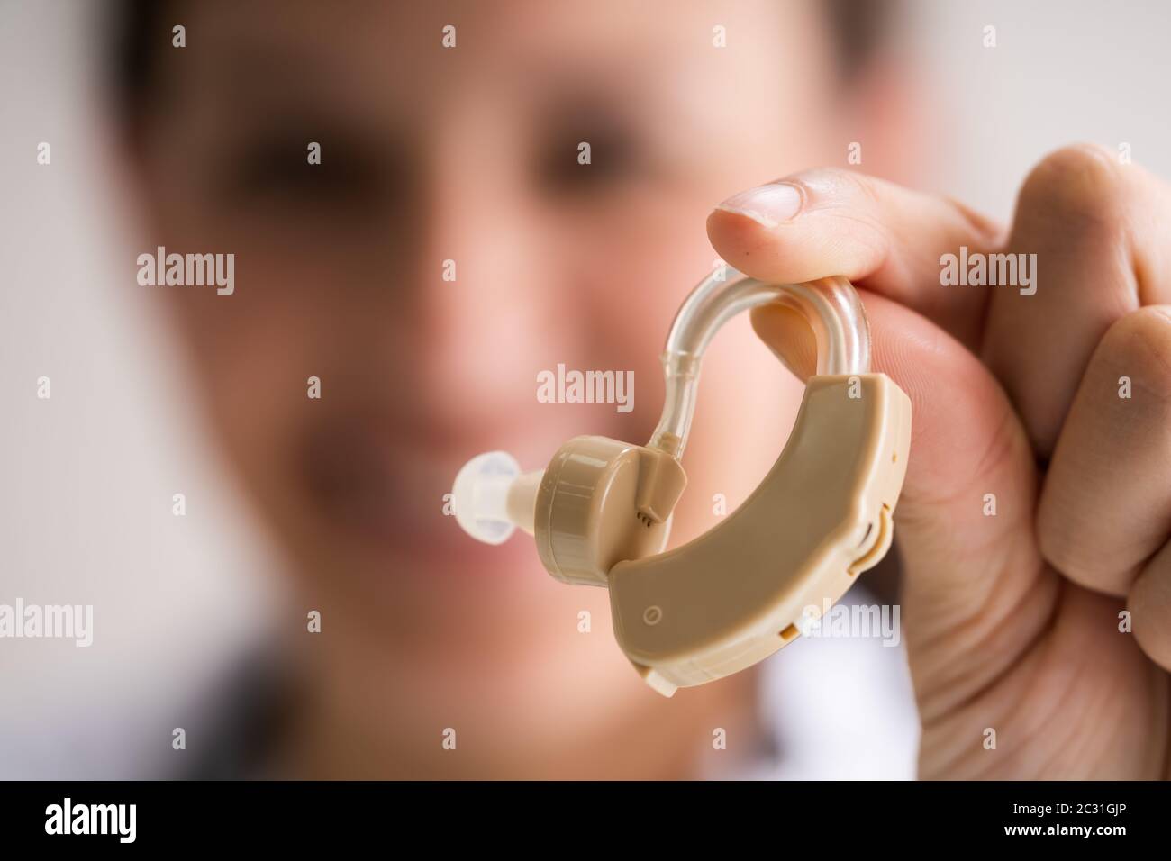 Audiologist Doctor Holding Hearing Deaf Aid In Hand Stock Photo Alamy