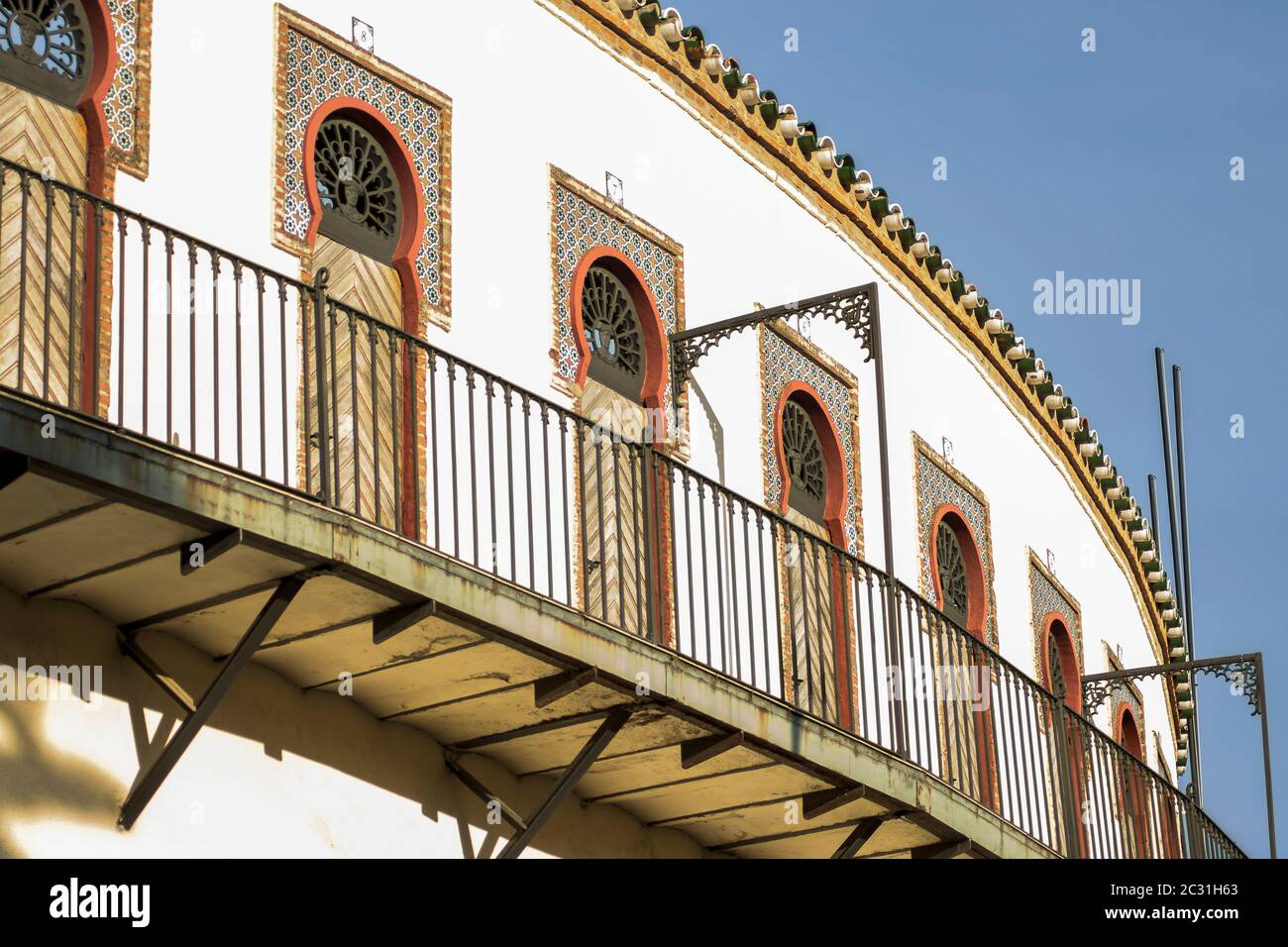 Outside balcony of the bullring of Almendralejo, in Spain, on a sunny spring afternoon with windows with arabesque elements Stock Photo
