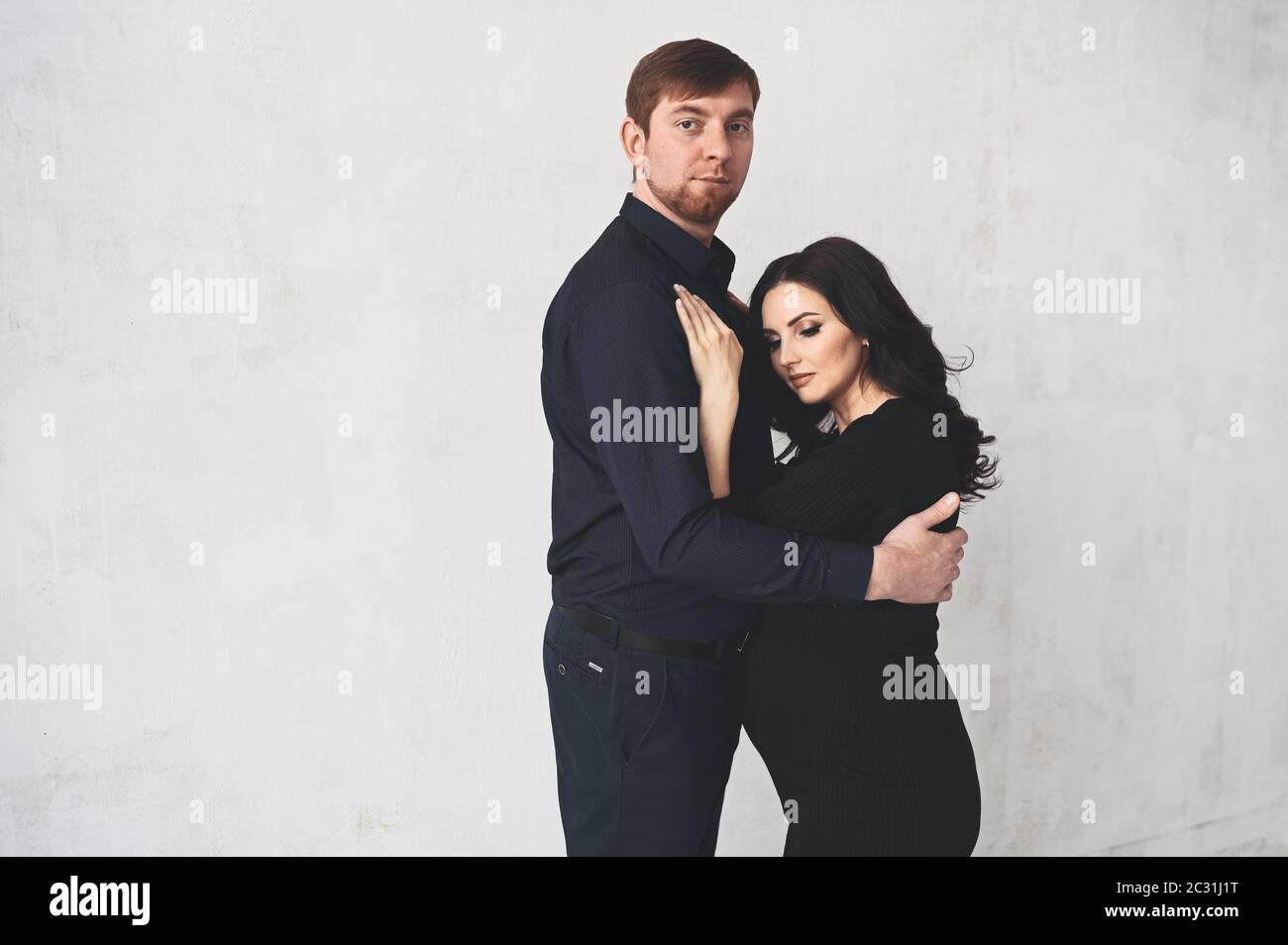 Pregnancy concept - happy man hugging his beautiful pregnant wife at ...