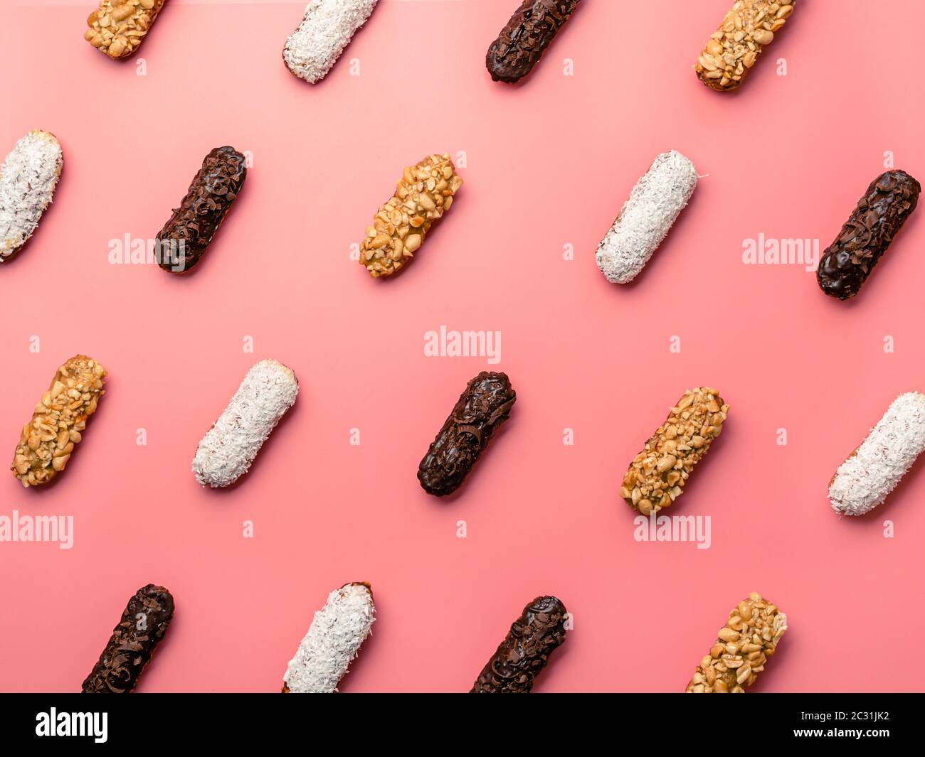 eclairs or profitroles pattern on pink background Stock Photo
