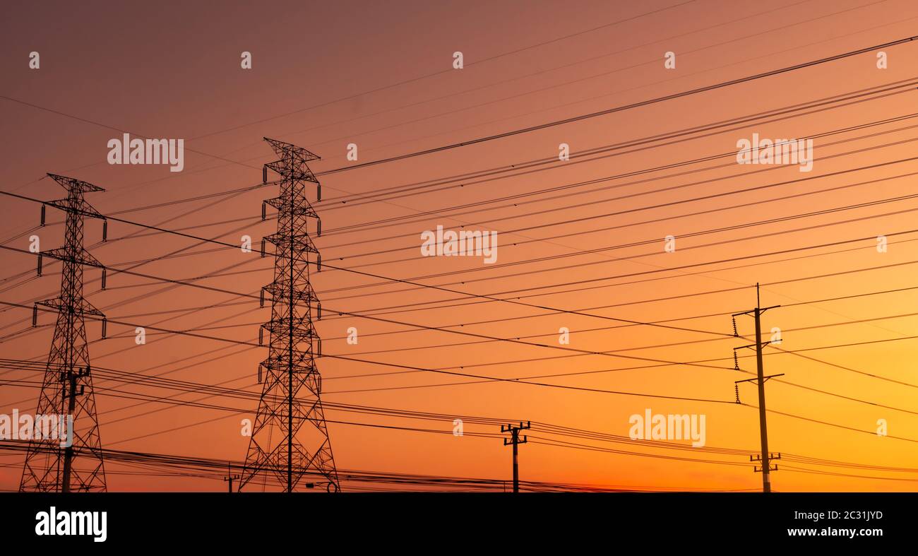 High voltage electric pylon and electrical wire with sunset sky ...