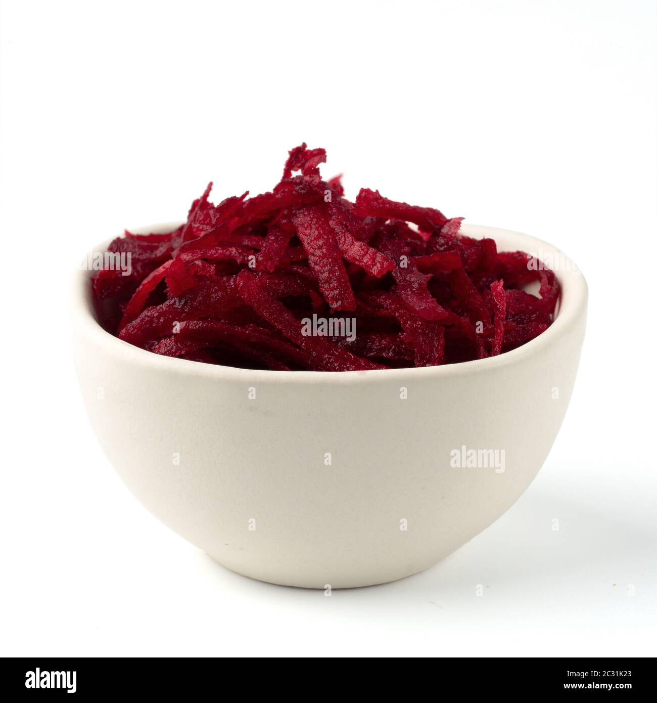 Grated beetroot in ceramic bowl isolated on white Stock Photo
