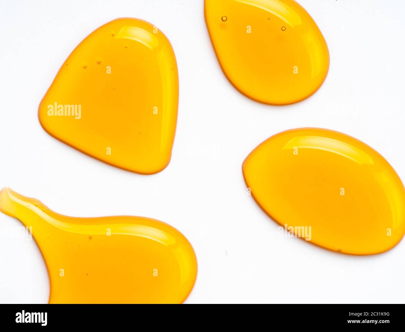 Honey drops abstract pattern, isolated on white Stock Photo