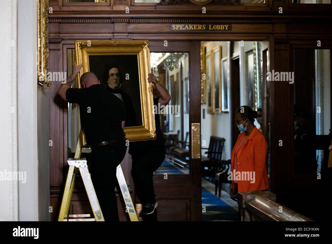 House Clerk Cheryl Johnson looks on as Architect of the Capitol maintenance workers remove a portrait of former Confederate House Speaker Howell Cobb, outside of the House Chambers in the US Capitol Building in Washington, DC on Thursday, June 18, 2020. House Speaker Nancy Pelosi ordered the paintings of four House speakers who served in the Confederacy to be removed. The portraits that were removed are of Robert Mercer Taliaferro Hunter of Virginia, Howell Cobb of Georgia, James Lawrence Orr of South Carolina and Charles Frederick Crisp of Georgia. Pool Photo by Nicholas Kamm/UPI Stock Photo
