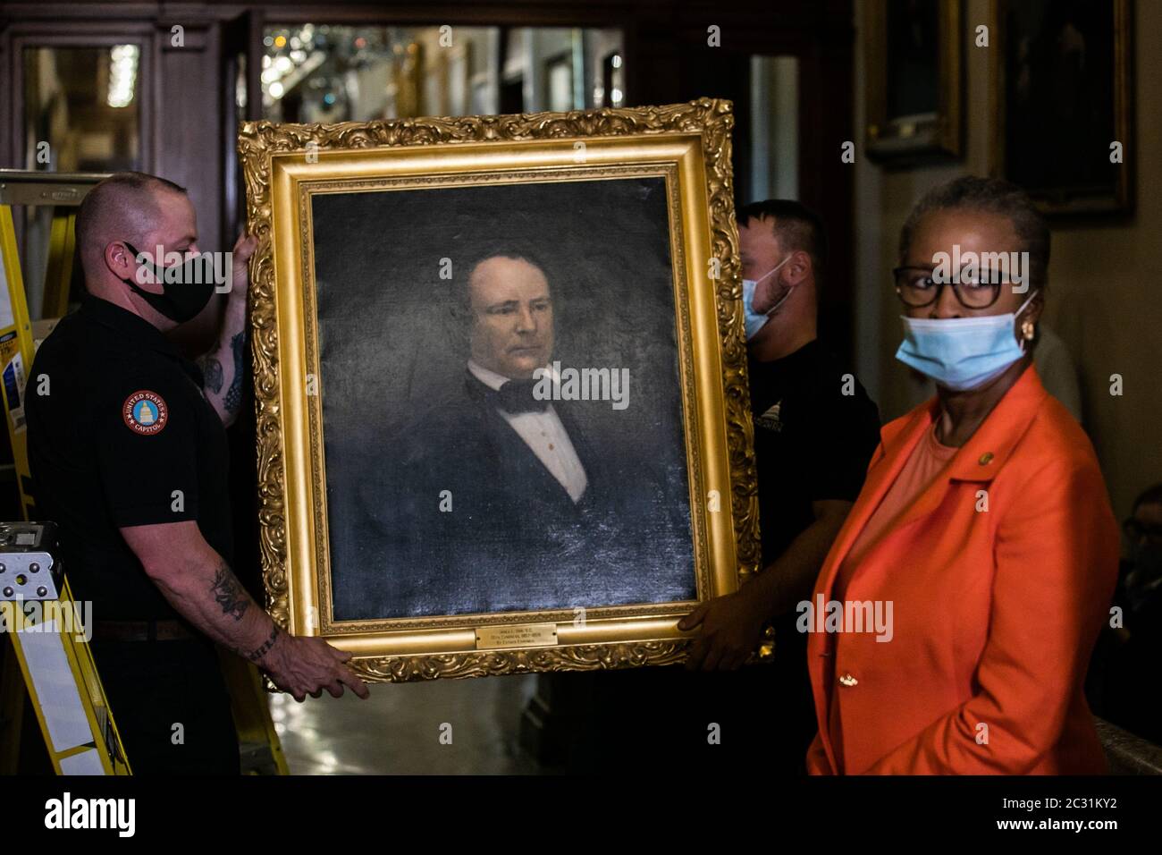 House Clerk Cheryl Johnson looks on as Architect of the Capitol maintenance workers remove a portrait of former Confederate House Speaker James Lawrence Orr, outside of the House Chambers in the US Capitol Building in Washington, DC on Thursday, June 18, 2020. House Speaker Nancy Pelosi ordered the paintings of four House speakers who served in the Confederacy to be removed. The portraits that were removed are of Robert Mercer Taliaferro Hunter of Virginia, Howell Cobb of Georgia, James Lawrence Orr of South Carolina and Charles Frederick Crisp of Georgia. Pool Photo by Nicholas Kamm/UPI Stock Photo