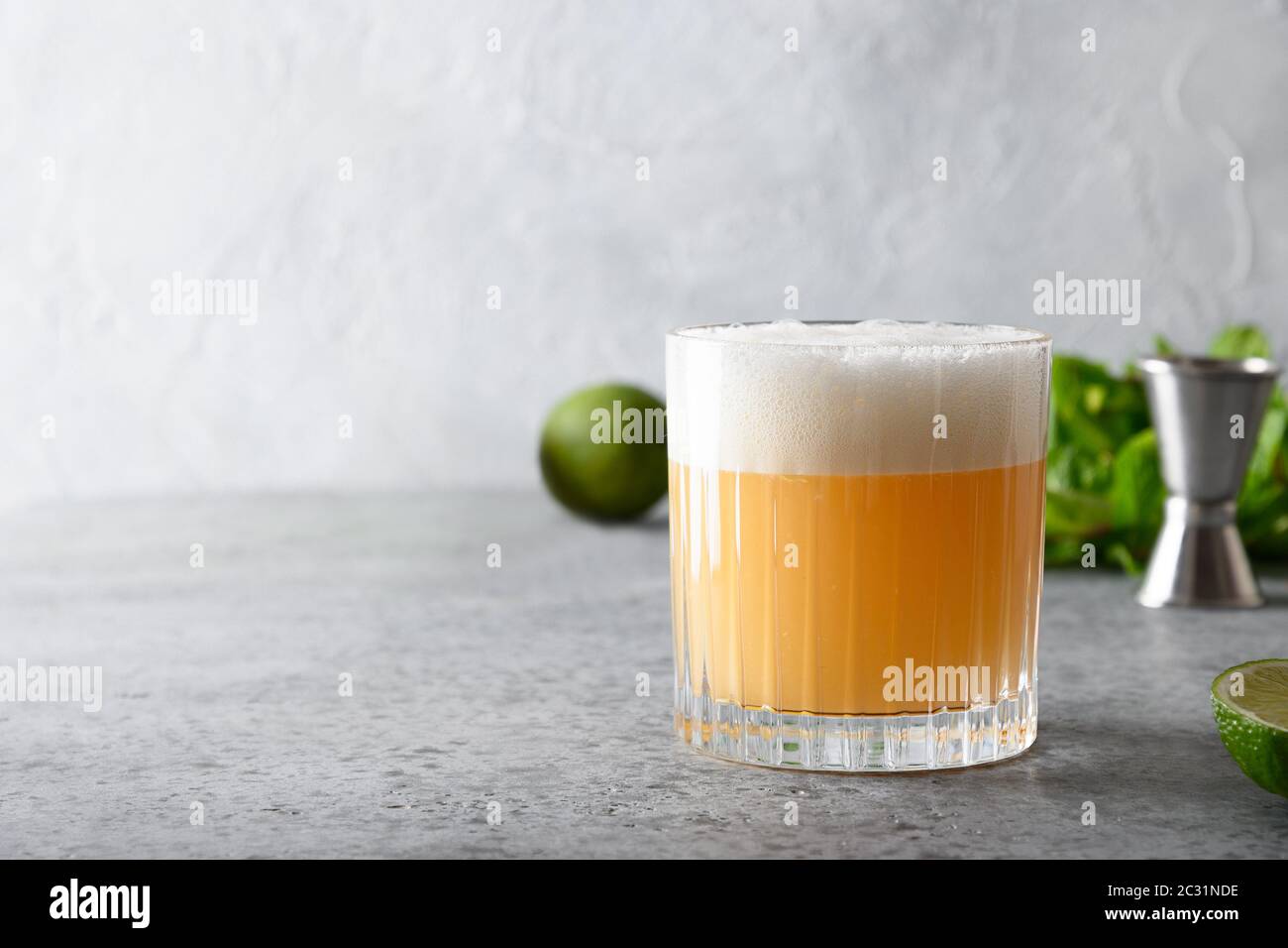Pisco sour cocktail whiskey with lime juice, sugar syrup and egg white in glass Stock Photo
