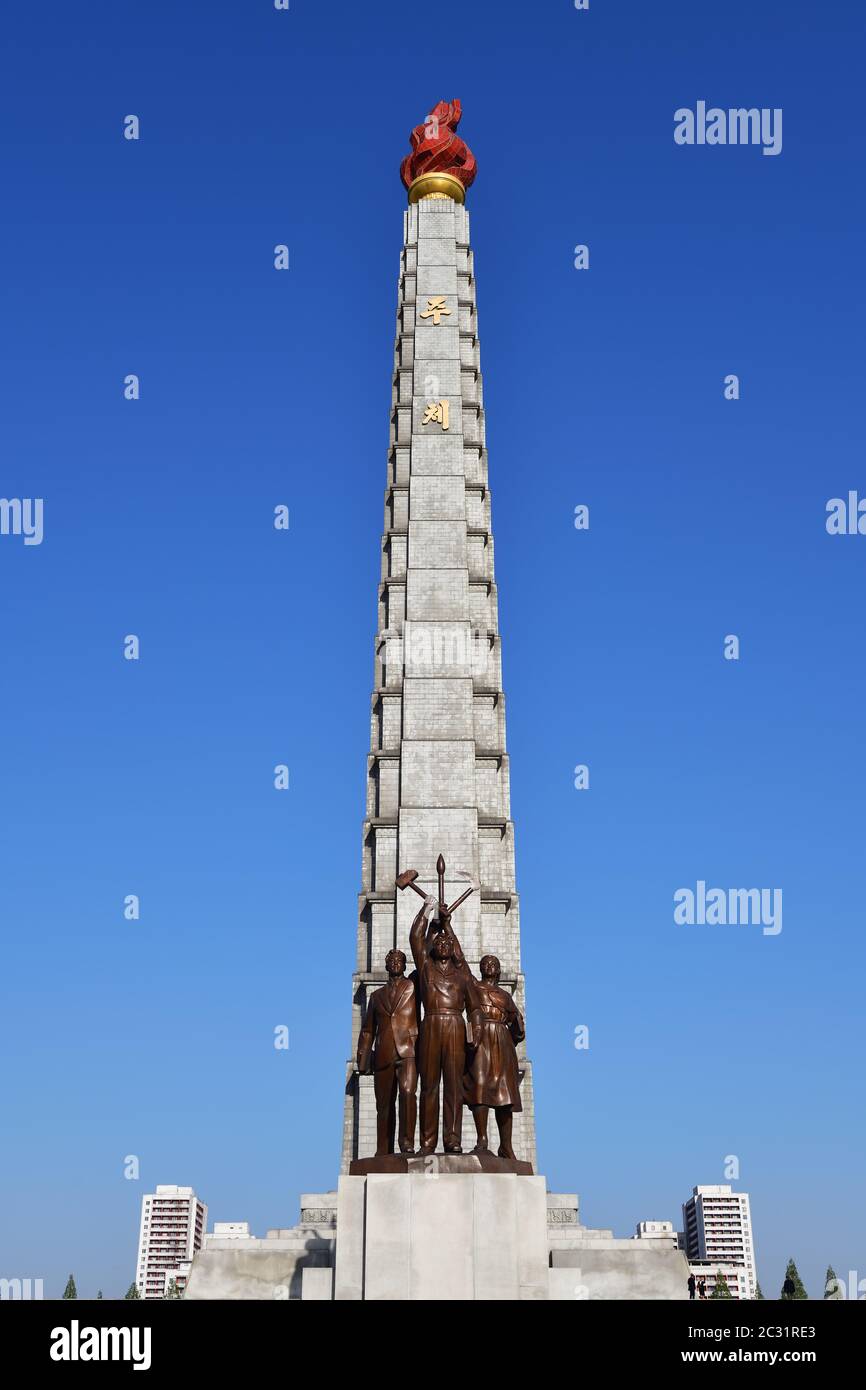 Pyongyang, North Korea - May 1, 2019: Tower of the Juche Idea and statue consisting of three idealised figures - worker, peasant and working intellect Stock Photo