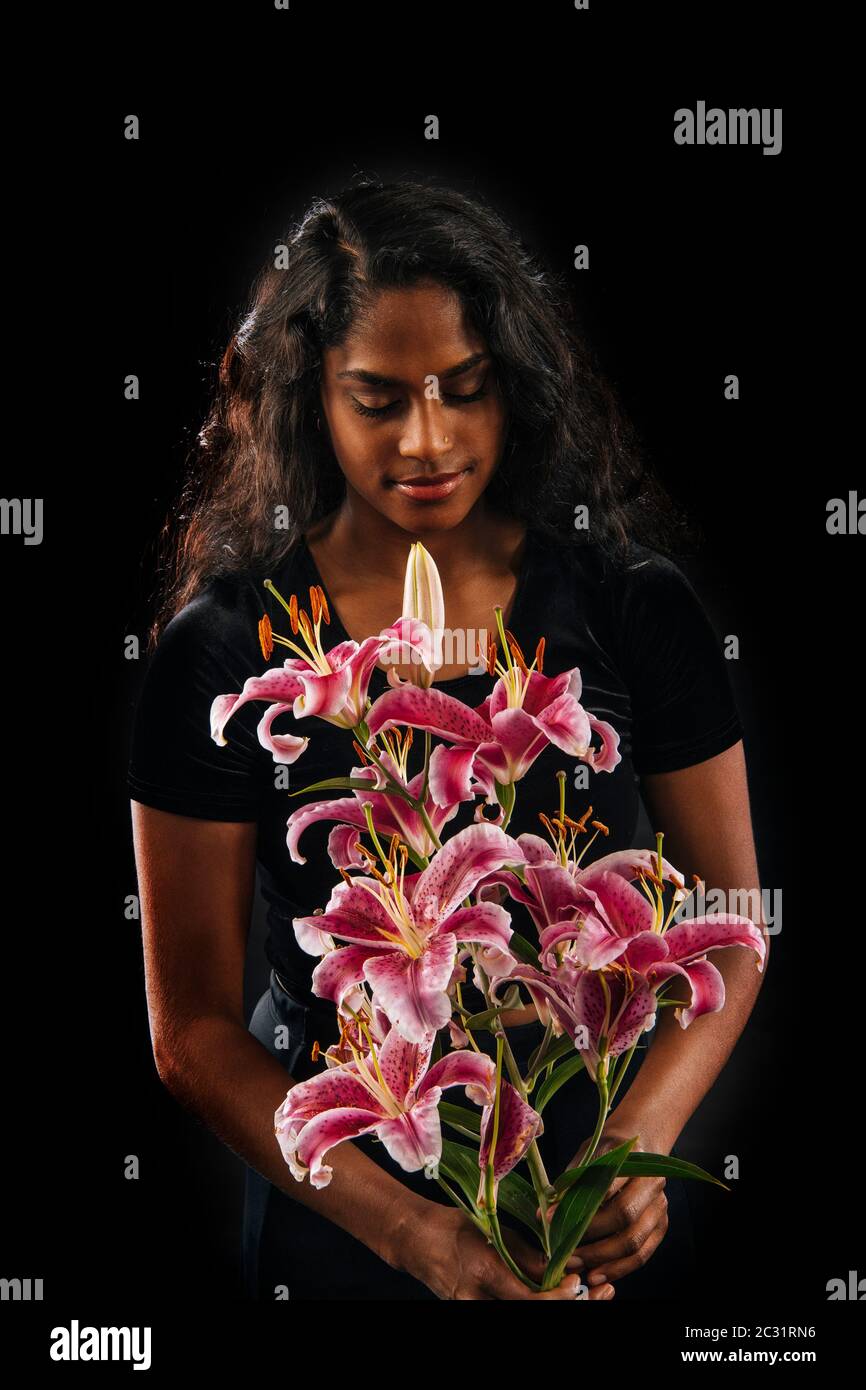 Woman holding lily flowers Stock Photo