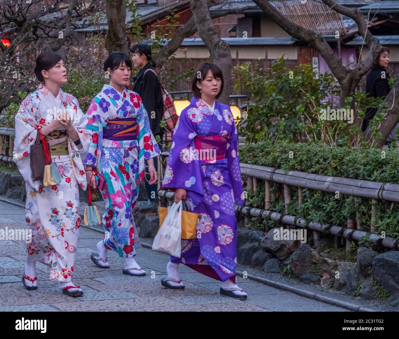 Japanese girls in kimono walking in the street of Gion, Kyoto, Japan at  dusk Stock Photo - Alamy