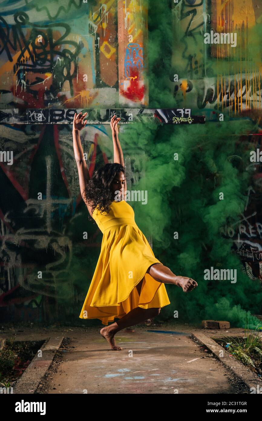 View of modern dancer and graffiti on background Stock Photo