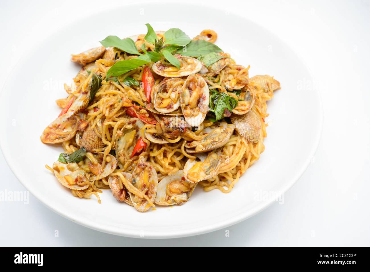 Stir fried noodles with clams and herbs, hot and spicy dish Stock Photo