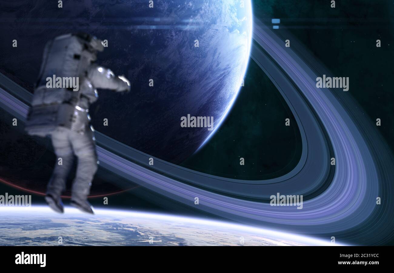 Astronaut on background of blue with a system of rings in far