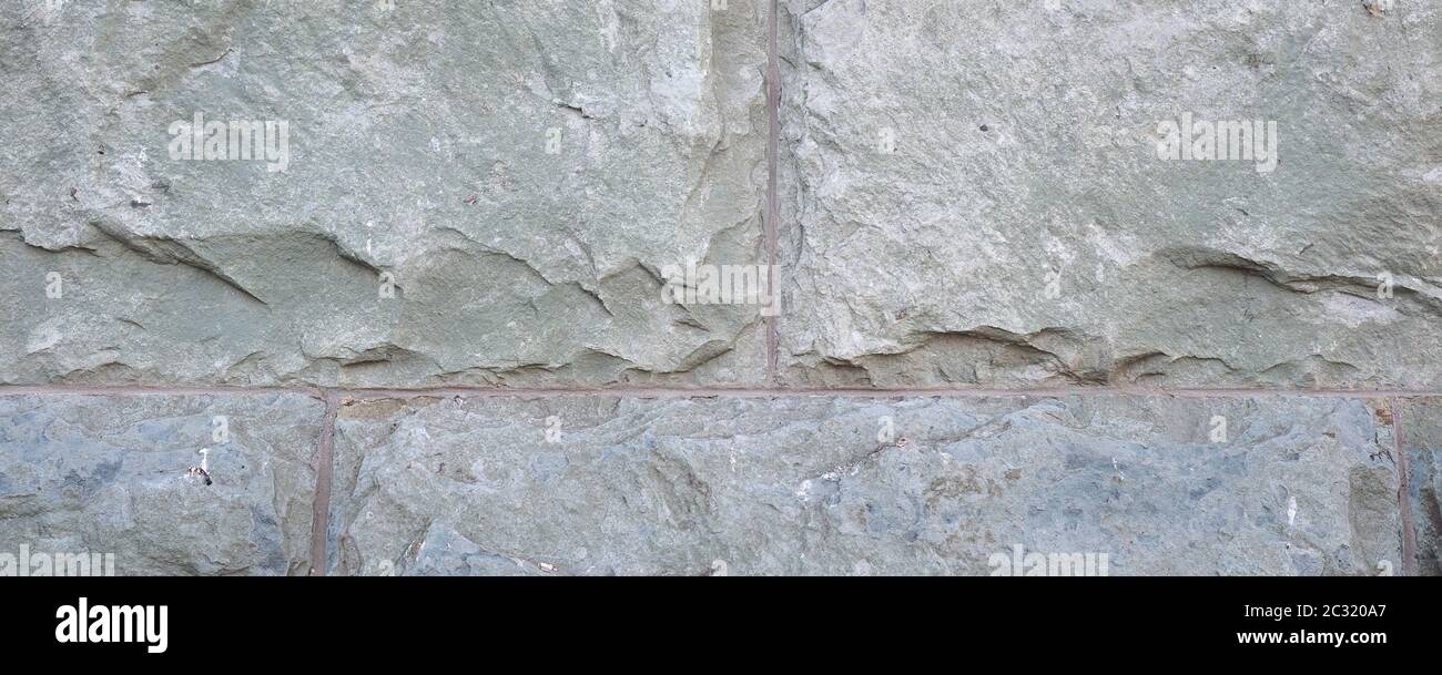 wide grey stone wall useful as a background Stock Photo - Alamy