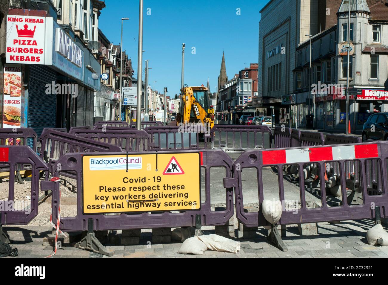 Covid 19 sign on highway construction site to protect Blackpool Council key workers from corona virus. Blackpool Lancashire England United Kingdom Stock Photo