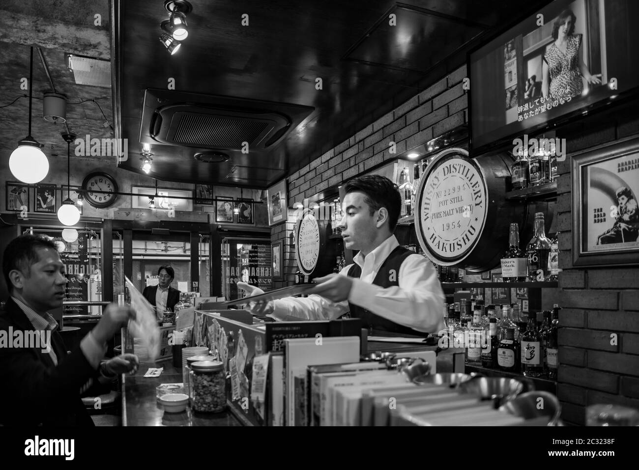 Interior of a whisky bar serving the well-known highball. Salarymen relaxing moments after working day. Tokyo, Japan. Stock Photo