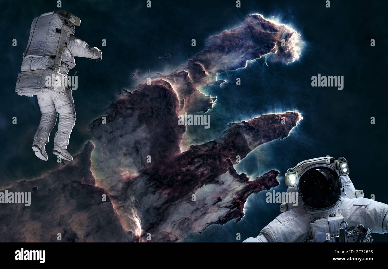 Astronauts on background of the Pillars of Creation. Deep space. Science fiction Stock Photo